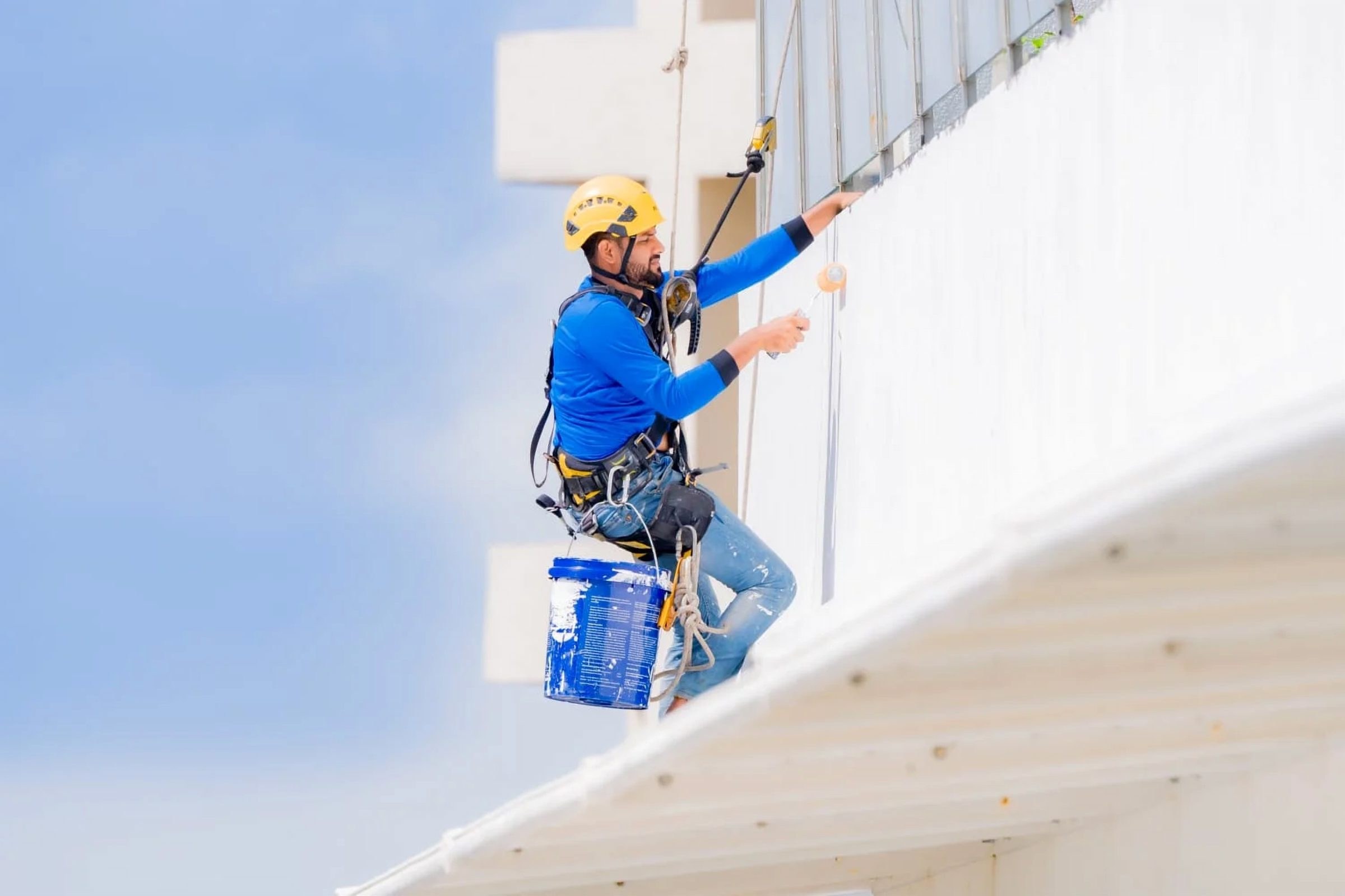 Phoenix rope access technician applying sealant to a building facade